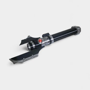 May include: A black and silver lightsaber with a red button and two blade-like extensions. The handle is black with silver accents. The overall design is futuristic and sleek.
