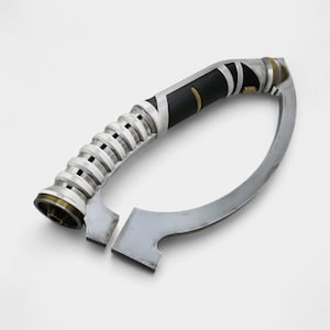 May include: A silver and black curved lightsaber hilt with a unique design. The hilt features a black grip with gold accents, a ribbed section, and a curved blade-like extension. The overall aesthetic is futuristic and stylized.
