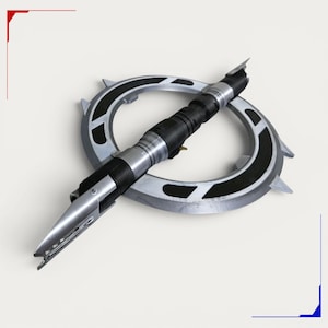 May include: A double-bladed spinning lightsaber hilt featuring a central circular ring component with silver and black accents. The handle is cylindrical with textured black grip sections and metallic silver detailing, extending into a pointed emitter.
