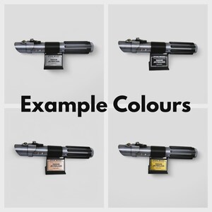 May include: Four silver lightsaber replicas with black handles and a gold plaque that reads "STAR WARS  DARTH VADER  LIGHT SABER". Example Colours.