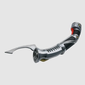 May include: A silver and black lightsaber with a curved handle and a silver blade. The lightsaber has a black grip with a silver accent and a red button on the side.