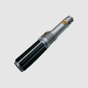 May include: A silver-toned cylindrical prop handle featuring a textured grip section with vertical black bars, a central knurled metallic band, and a circular gold-colored activation button positioned near the top emitter section.