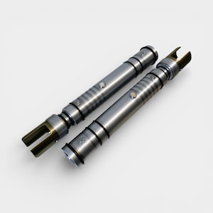 May include: Two metallic silver lightsabers with gold accents. The lightsabers have a cylindrical design with detailed ridges and black rings. Each saber features a button and a gold-colored emitter.