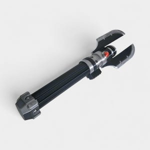May include: A black and silver lightsaber prop with a red button and two curved blades. The hilt is black with silver accents. The lightsaber is a prop from a science fiction movie.