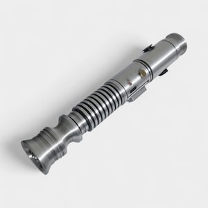May include: A metallic silver lightsaber with a ribbed handle and detailed design. The hilt features a series of buttons and a circular activation switch. The lightsaber is a prop or collectible item.