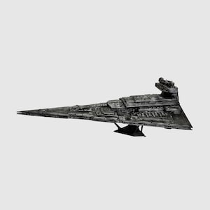 May include: A detailed, dark gray model of a Star Destroyer spaceship. The model is triangular with intricate surface details, a prominent command tower, and is mounted on a black stand. The spaceship is a replica of a fictional spacecraft.