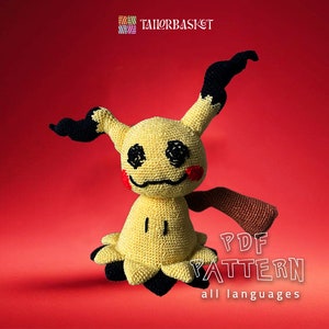 May include: A crocheted Mimikyu plushie in yellow, black, and red, with a smiling face and a long, brown arm. The plushie is set against a red background. Text on the image reads "PDF PATTERN all languages".