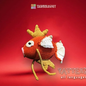May include: A crocheted orange and white fish with a yellow crown. The fish is on a red background. The text "PATTERN all languages" is below the fish.