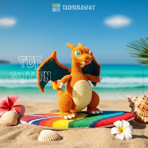 May include: A crocheted orange dragon toy with blue wings and a cream-coloured belly stands on a rainbow surfboard on a sandy beach. The words "PDF PATTERN" are in white text. The Tailorbasket logo is in the top right corner.