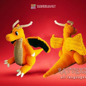 May include: A crocheted orange dragon with green wings. The dragon is sitting on a red background. The text "PATTERN all languages" is at the bottom of the image.