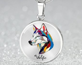 May include: A silver necklace with a round pendant featuring a colorful mosaic wolf design. The pendant has the word "Wolfie" inscribed below the wolf.