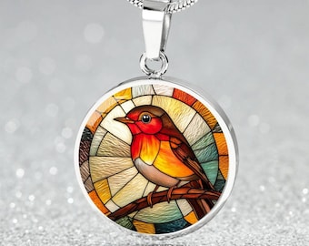 May include: A silver chain necklace with a round pendant featuring a stained glass style robin bird with red, orange, yellow, and blue colors.