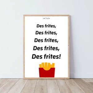May include: A white framed print with the text "Les Tuche" and the phrase "Des frites" repeated five times, followed by an exclamation point. A cartoon image of a red box of french fries is below the text.