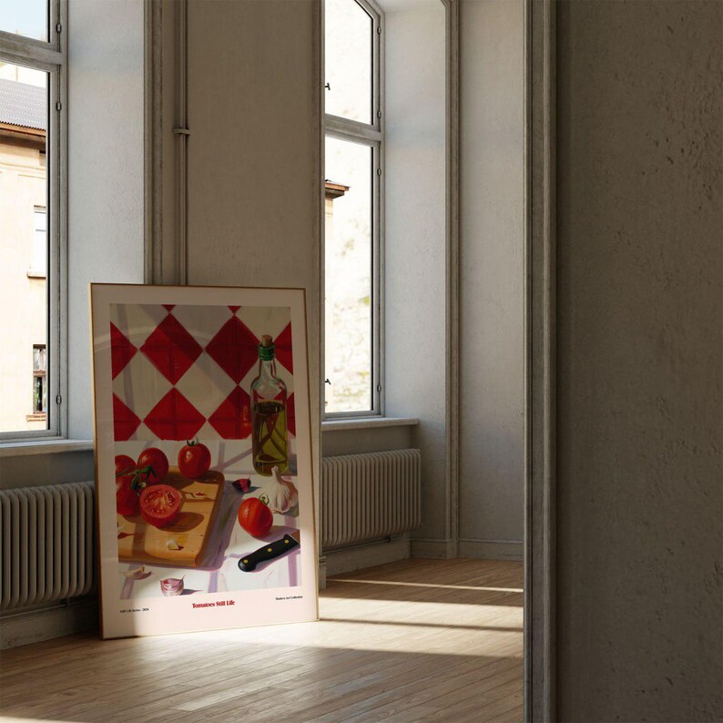 May include: A framed print of a still life featuring red tomatoes, a bottle of olive oil, garlic cloves, and a knife on a red and white checkered surface. The print has the text "Saturdays Still Life" at the bottom.