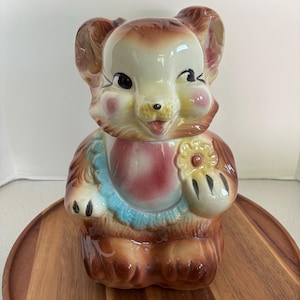 Vintage Baby Teddy Bear Cookie Jar, Wearing a Pink Bib, Holding Yellow Cookie, Blue Bow, American Bisque 1950's, Great Vintage Condition