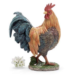 May include: A detailed figurine of a rooster, featuring a red comb and wattle, with a mix of orange, brown, and blue feathers. The rooster stands on a small, grassy base, with a few white flowers nearby. The sculpture is a decorative item.