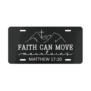 May include: Black and white license plate with the text "FAITH CAN MOVE mountains" and "MATTHEW 17:20". The design features a cross and mountains.