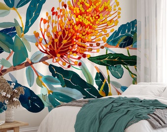 Puede incluir: Mural floral de acuarela con una flor grande y vibrante en tonos rojos, naranjas y amarillos. El diseño incluye hojas verdes y azules sobre un fondo blanco, creando un tema botánico. El mural está instalado sobre una cama con una manta verde azulado.