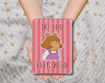 May include: A rectangular phone case with a pink striped background and the text "DO YOU EVEN READ" in red. The case features a cartoon illustration of a character with brown hair and a purple dress.