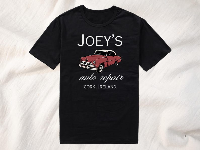 May include: Black t-shirt with white text that reads "JOEY'S auto repair CORK, IRELAND". A vintage red car is pictured above the text.