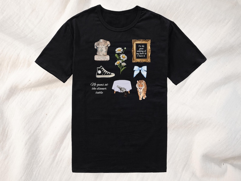 May include: Black t-shirt with a white graphic design featuring a statue, flowers, a shoe, a table, a gun, a bow, and a tiger. The text on the shirt reads "I'm the great undoing of my heart if I knew it" and "No guns at the dinner table."