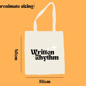 May include: A white tote bag with black text that reads "Written Rhythm" and two white stars. The bag is 40 cm tall and 38 cm wide.