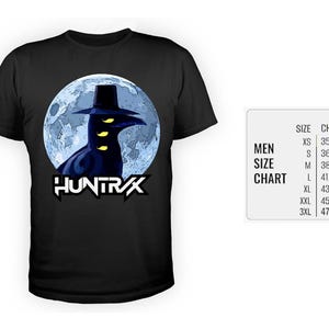 May include: Black t-shirt featuring a graphic of a dark figure with a hat and glowing yellow eyes against a blue moon backdrop. The word "HUNTRAX" is displayed in white, stylized text. A size chart is visible.
