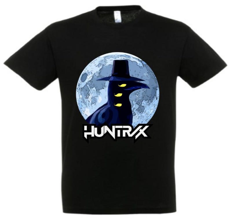 May include: Black t-shirt featuring a graphic of a crow-like figure wearing a hat, set against a blue moon backdrop. The word "HUNTR/X" is printed in white below the image. The shirt is made of a soft material.