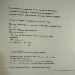 May include: A printed page with text from a book titled "The Sun: symbol of power and life" compiled by Madanjeet Singh. The text includes Library of Congress Cataloging-in-Publication Data and copyright information.