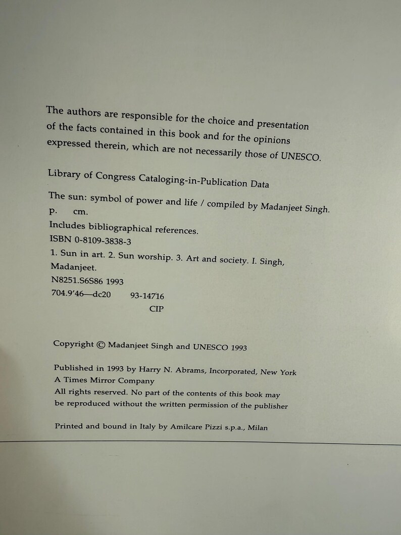May include: A printed page with text from a book titled "The Sun: symbol of power and life" compiled by Madanjeet Singh. The text includes Library of Congress Cataloging-in-Publication Data and copyright information.