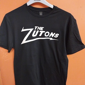 The zutons indie rock n roll arctic monkeys cool bugg guitar music fratellis blink 182 sum 41 UNISEX T shirt