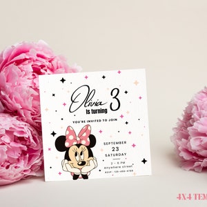 May include: A white invitation card with pink and black accents. The card features a cartoon image of Minnie Mouse with a pink bow and polka dot dress. The text on the card reads "Olivia is turning 3" and includes details for a birthday party.