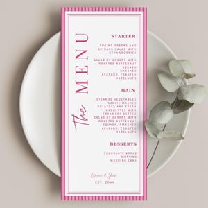 May include: A vertical rectangular menu card with a white background and magenta striped borders. The text reads THE MENU, STARTER, MAIN, DESSERTS, and lists food items including spring greens, roasted butternut squash, and chocolate apple muffins.