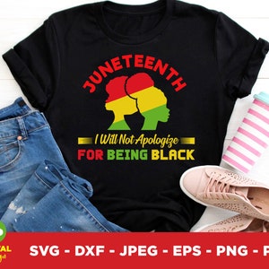 May include: Black t-shirt with the text "Juneteenth" in red, and the phrase "I Will Not Apologize For Being Black" in white and yellow. The design includes silhouettes of two women in red, yellow, and green. The shirt is paired with blue jeans and pink shoes.