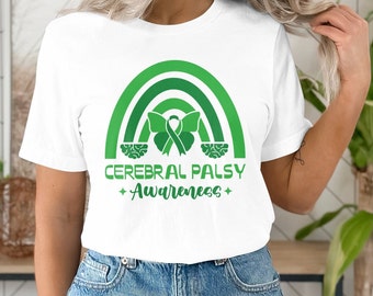 May include: White t-shirt with a green rainbow design and a green ribbon with a butterfly on each side. The text "Cerebral Palsy Awareness" is printed below the rainbow.