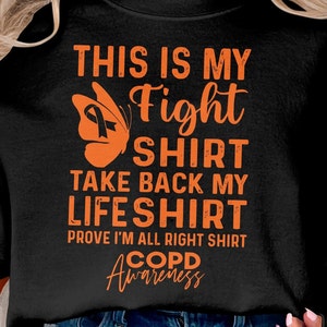 Puede incluir: Camiseta negra con texto naranja que dice "This is my Fight Shirt Take Back My Life Shirt Prove I'm All Right Shirt COPD Awareness" con un gráfico de mariposa naranja con una cinta negra.