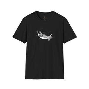 May include: Black t-shirt with a graphic of a woman lying on a crescent moon with stars.