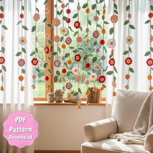 May include: Crocheted floral curtain with hanging strands of colorful flowers and green leaves. The flowers are in shades of red, orange, pink, purple, and white. The text "PDF Pattern Download" is in a pink bubble.