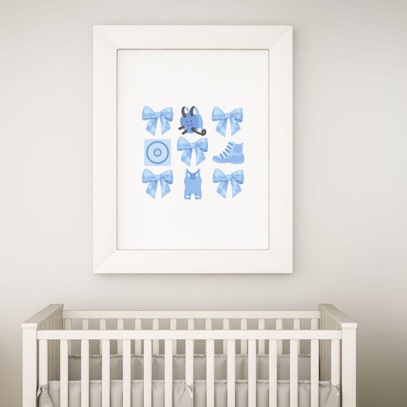 May include: A framed print with a blue and white design featuring a baby's outfit, a shoe, a bow, and a pacifier.