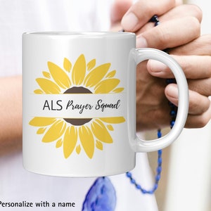 May include: White ceramic mug with a sunflower design and the text "ALS Prayer Squad".