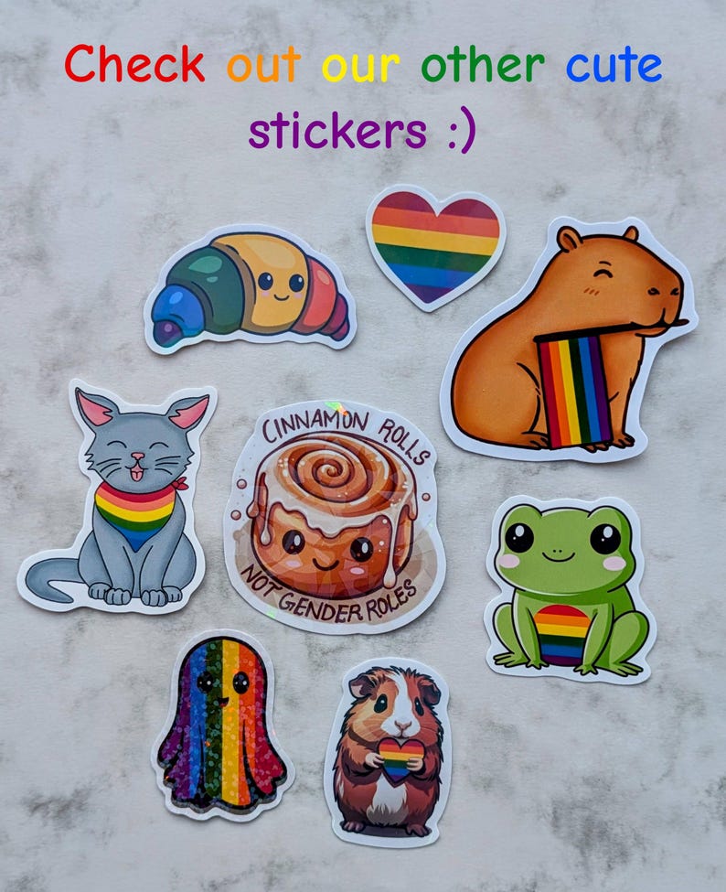 May include: A selection of colourful stickers featuring cartoon animals and food. Stickers include a croissant, heart, capybara, cat, cinnamon roll, ghost, guinea pig, and frog, all with rainbow accents. Text on the stickers reads "Cinnamon Rolls" and "Not Gender Roles."