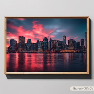 May include: A panoramic view of a city skyline at sunset. The city is silhouetted against a vibrant pink and orange sky, with the water reflecting the colors of the sunset. The buildings are tall and modern, with many windows.
