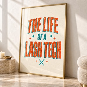 May include: A framed wall art print featuring the text THE LIFE OF A LASH TECH in orange glittery letters with a teal outline. The design includes small teal and orange star accents and a graphic of two crossed tweezers at the bottom centre.