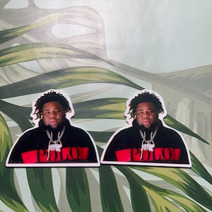 May include: Two stickers featuring a black and white photo of a person wearing a black hoodie with the word "POLO" in red letters on the front. The person is wearing a silver chain necklace.