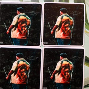 May include: Four square stickers featuring a black and white image of a person wearing a red, white, and blue shirt. The text "Lost Boy" and "800 WAVE" is printed on the sticker.