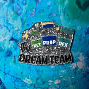 The DreamTeam  - flatback- resin charms- bow centers- pendants- badge reels- epoxy charms- resin Charms- flatback planars- planars - charm