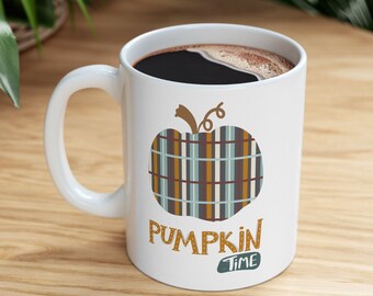 May include: White ceramic mug with a brown and blue plaid pumpkin design and the text "Pumpkin Time".