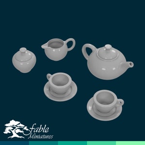 May include: A white porcelain tea set comprising a teapot, creamer, sugar bowl, two cups and saucers. The set is displayed against a blue background.