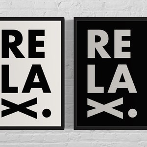 May include: Two framed prints with the word "RELAX" in black and white text on a white and black background.