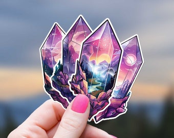 May include: A sticker featuring a cluster of four purple and pink crystal shapes with a landscape scene inside each crystal. The crystals are arranged in a cluster and have a glossy finish.
